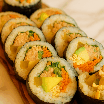 Close-up of Korean kimbap rolls filled with tuna, egg, carrots and pickled radish